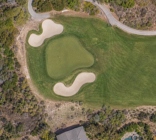 Aerial view of a putting green and sand bunkers